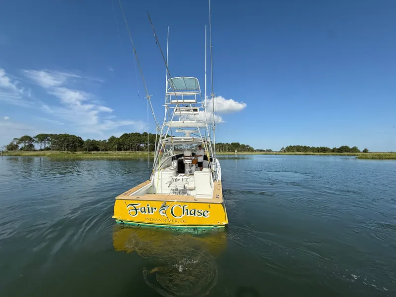 Slide: The Image of A 1993 Custom Gary Davis Carolina boat on calm water with a clear sky. - 6