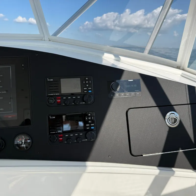 Slide: The Image of The cockpit of a boat with modern navigation equipment and a clear view of the sky. - 27
