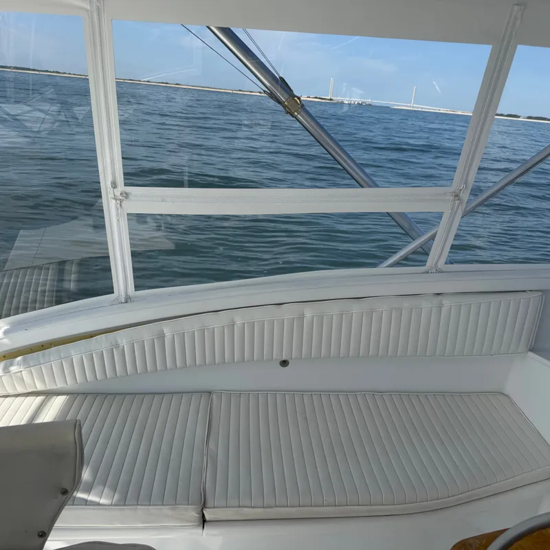 Slide: The Image of The image shows a boat cockpit with white upholstery and a view of the water. - 29