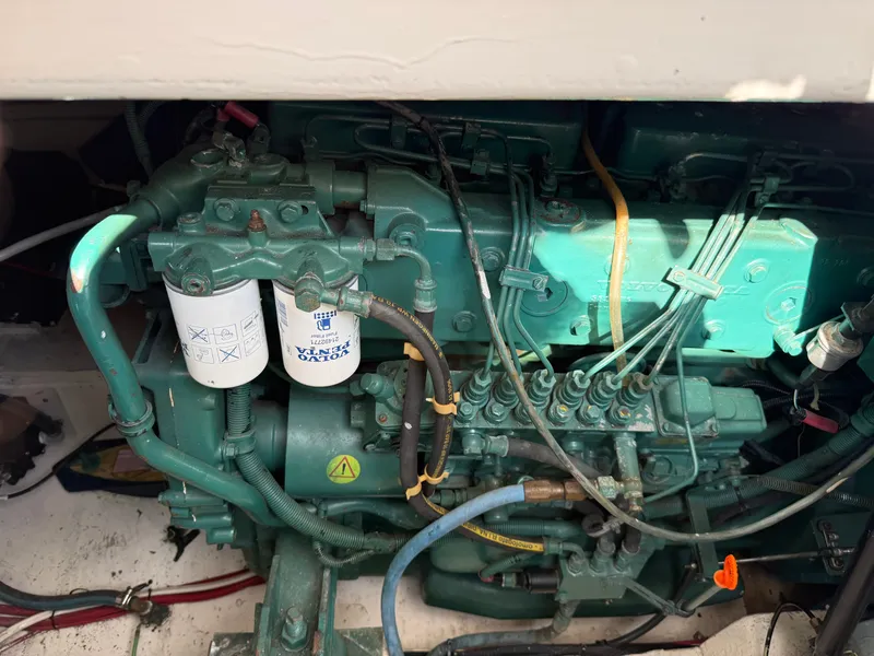 Slide: The Image of A green engine with various hoses and wires is installed in a boat. - 45