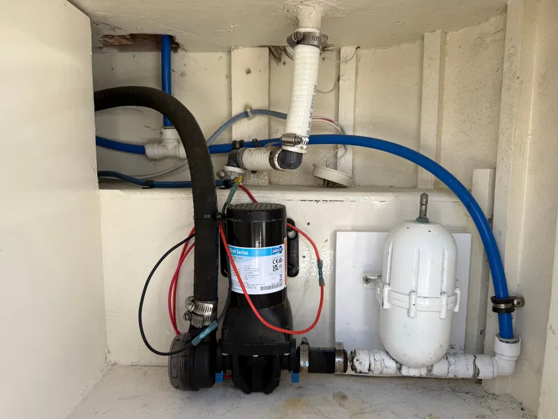 Slide: The Image of A technical area with hoses and a pump inside a boat. - 22