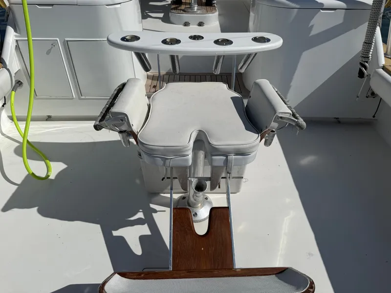 Slide: The Image of A fishing chair on a boat with multiple rod holders and padded armrests. - 18