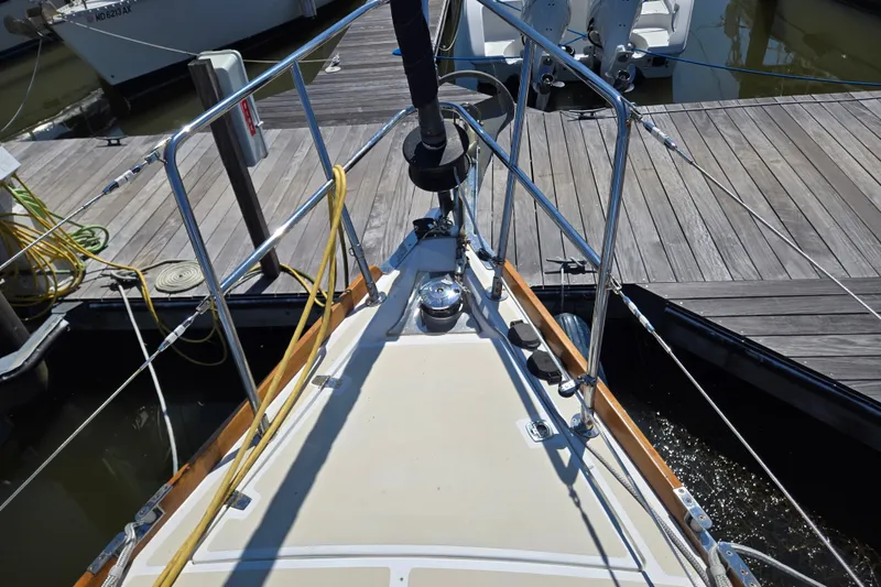 Slide: The Image of Bow of 2005 Tartan 3700 sailboat docked at marina with visible deck fittings. - 5