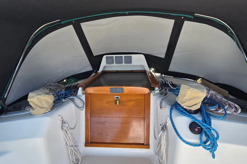 Slide: The Image of Interior view of a 2005 Tartan 3700 sailboat cockpit with ropes and wooden hatch. - 11