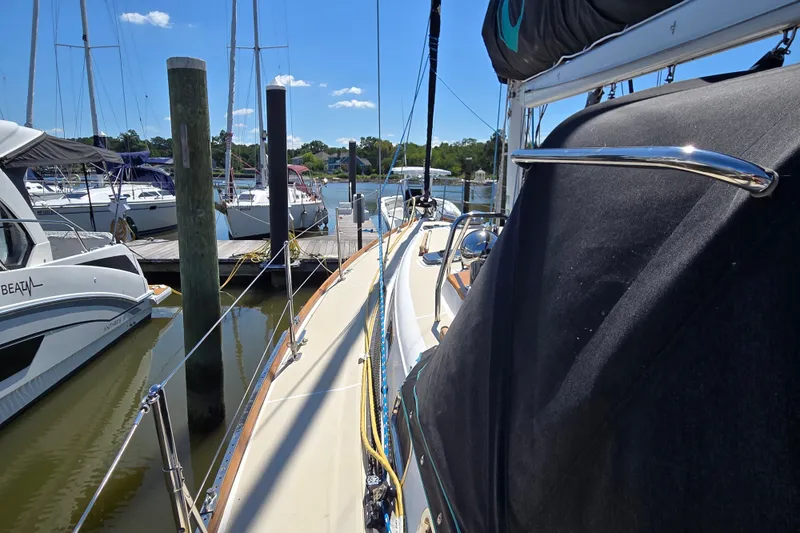 Slide: The Image of 2005 Tartan 3700 sailboat docked at marina under clear blue sky. - 8