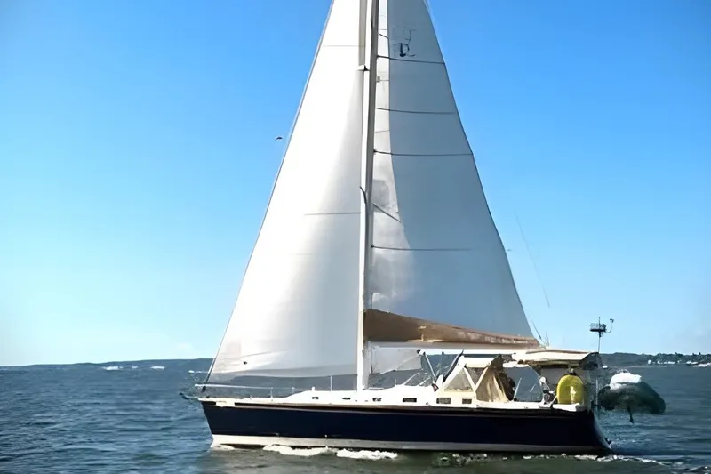 Slide: The Image of Sailing yacht Tartan 3700, 2005 model, cruising on open water under clear blue skies. - 58