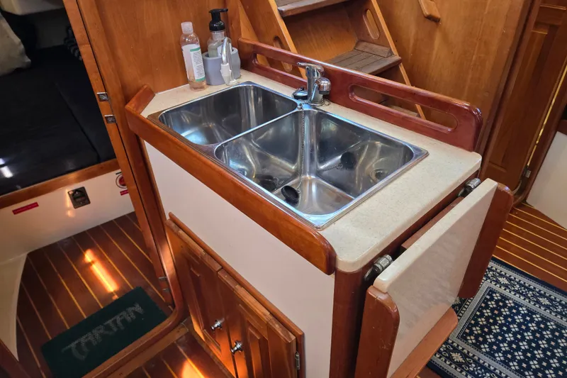 Slide: The Image of Compact kitchen sink area in a 2005 Tartan 3700 yacht interior. - 34