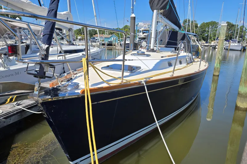 Slide: The Image of Sailboat Tartan 3700, 2005 model, docked in a marina with clear blue skies. - 3