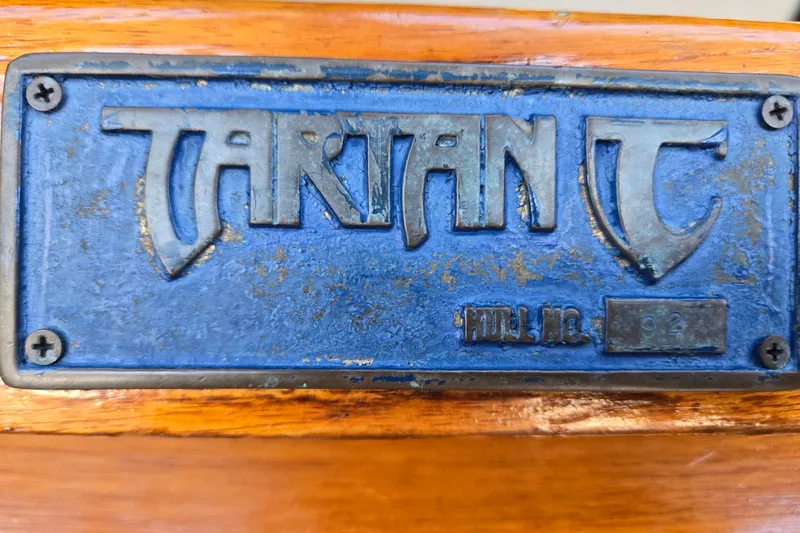 Slide: The Image of Blue Tartan 3700 nameplate, hull number 92, on wooden surface, 2005 model. - 19