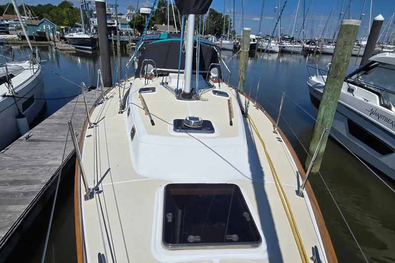 Slide: The Image of 2005 Tartan 3700 sailboat docked at marina, surrounded by other boats. - 7