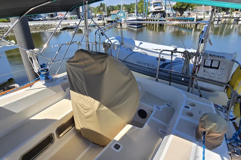 Slide: The Image of Sailboat cockpit of 2005 Tartan 3700 with covered wheel, docked near marina. - 10