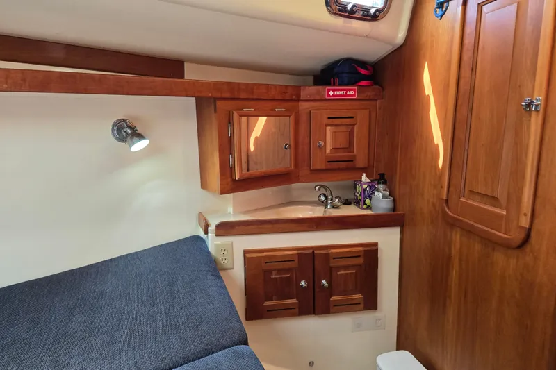 Slide: The Image of Cozy cabin interior of 2005 Tartan 3700 sailboat with wooden cabinetry and sink. - 43