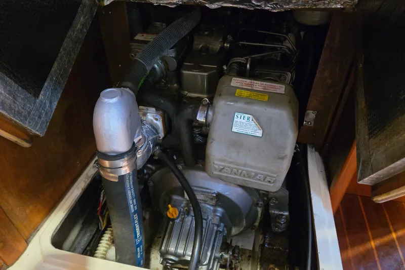 Slide: The Image of Engine compartment of a 2005 Tartan 3700 sailboat, featuring a Yanmar engine. - 46