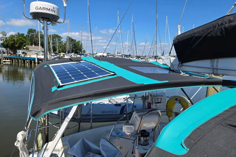 Slide: The Image of Sailboat with solar panel, Tartan 3700, 2005 model, docked in marina under clear blue sky. - 49
