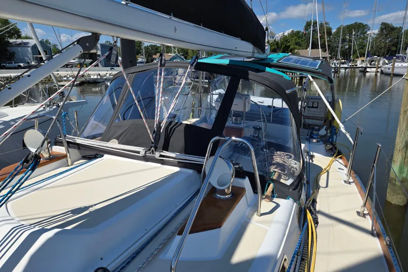 Slide: The Image of 2005 Tartan 3700 sailboat docked at marina, featuring deck and cockpit area. - 51