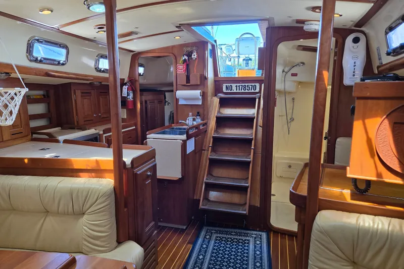 Slide: The Image of Interior of 2005 Tartan 3700 sailboat with wood finish and cozy seating area. - 26