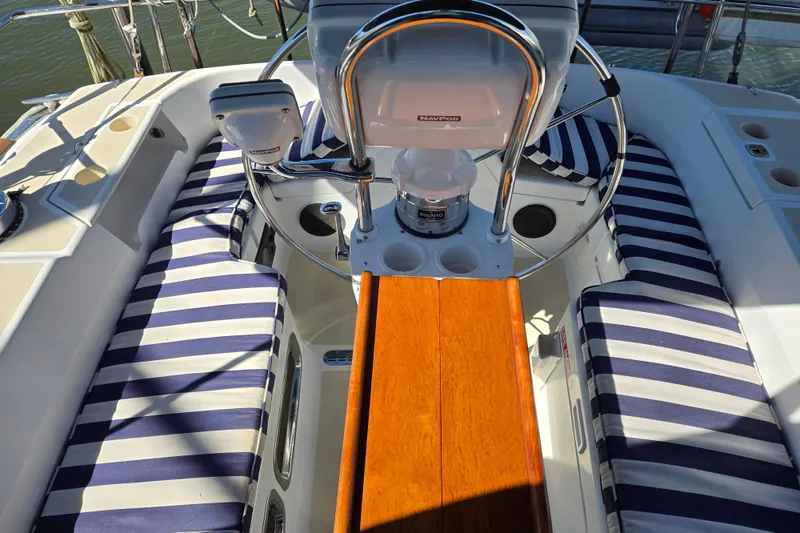 Slide: The Image of Cockpit of 2005 Tartan 3700 sailboat with striped cushions and steering wheel. - 14