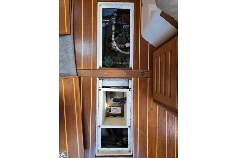 Slide: The Image of Wooden interior of a 2005 Tartan 3700 sailboat, showcasing storage compartments. - 48