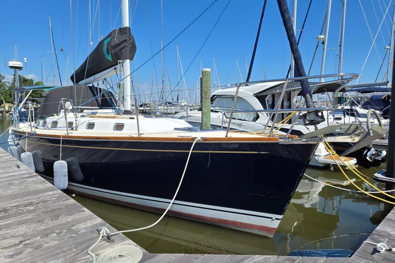 Slide: The Image of Sailboat Tartan 3700, 2005 model, docked at marina with clear blue sky. - 55