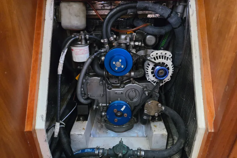 Slide: The Image of Engine compartment of a 2005 Tartan 3700 sailboat, featuring hoses and mechanical components. - 47
