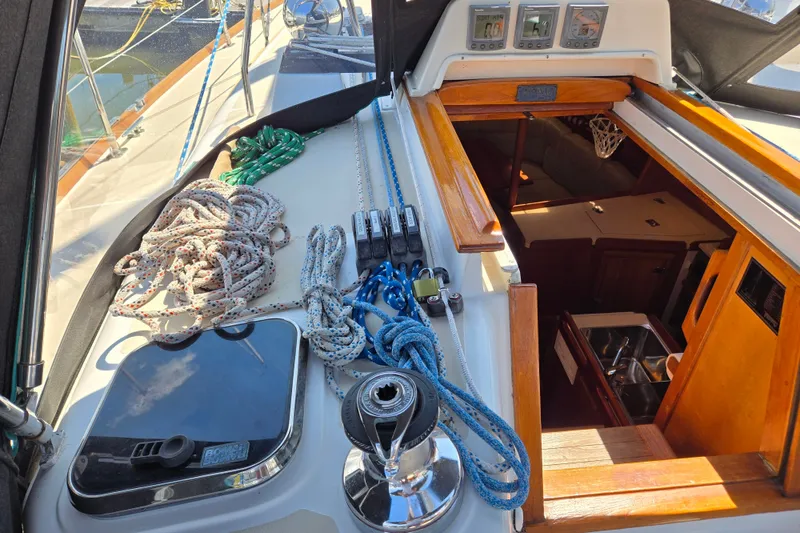 Slide: The Image of Deck view of a 2005 Tartan 3700 sailboat with ropes and cabin entrance. - 13
