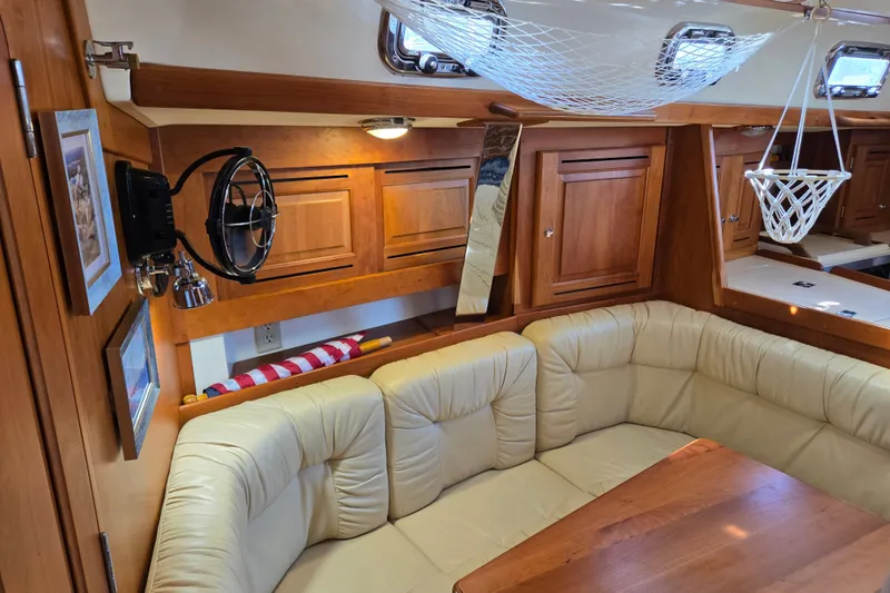 Slide: The Image of Luxurious interior of a 2005 Tartan 3700 yacht with leather seating and wooden cabinetry. - 28