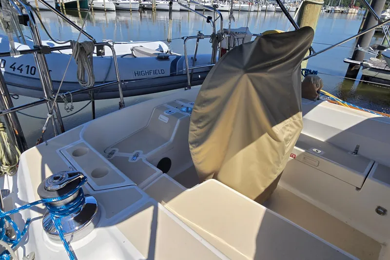 Slide: The Image of Cockpit of 2005 Tartan 3700 sailboat with covered wheel and marina view. - 9