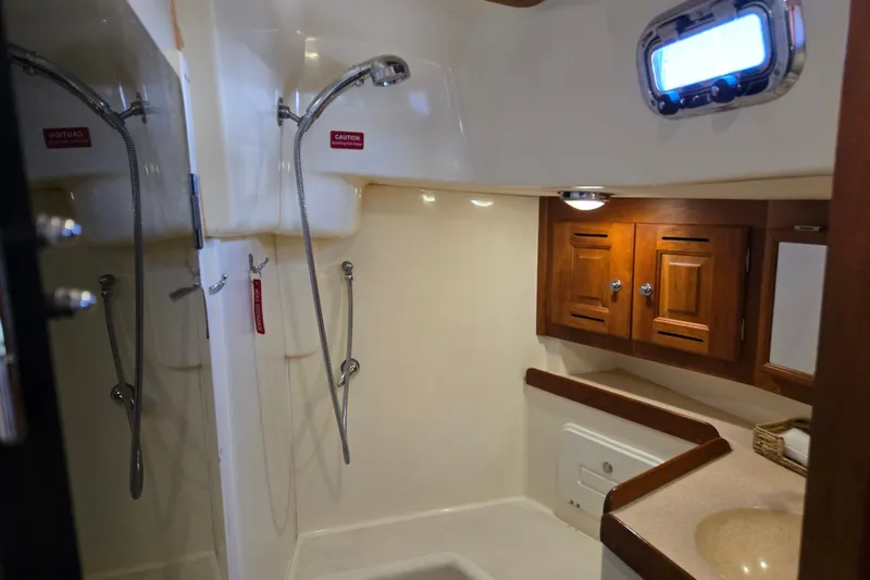 Slide: The Image of Interior of 2005 Tartan 3700 yacht bathroom with shower and wooden cabinets. - 39