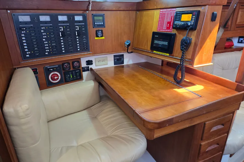 Slide: The Image of Navigation station of a 2005 Tartan 3700 yacht with control panels and seating. - 21