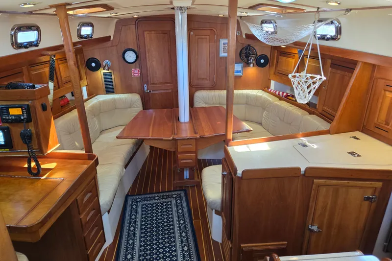 Slide: The Image of Interior of a 2005 Tartan 3700 sailboat with wood finish and cozy seating area. - 1