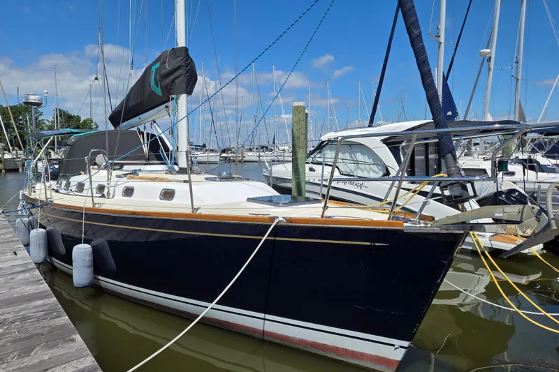 The Image of Sailboat Tartan 3700, 2005 model, docked at marina under clear blue sky. - 0