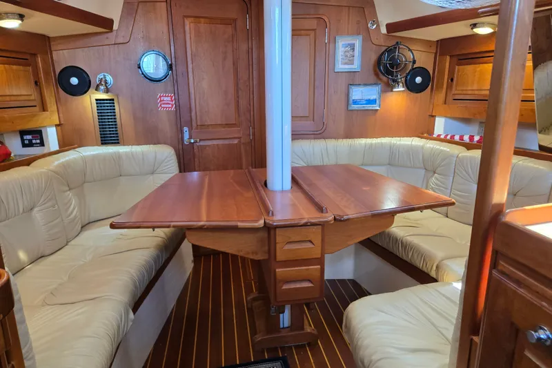 Slide: The Image of Luxurious interior of a 2005 Tartan 3700 yacht with wooden furnishings and cream seating. - 30