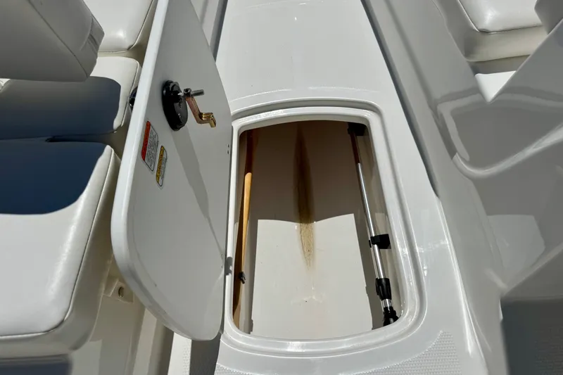 Slide: The Image of 2024 Tahoe T16 boat storage compartment with open hatch and seating area. - 65