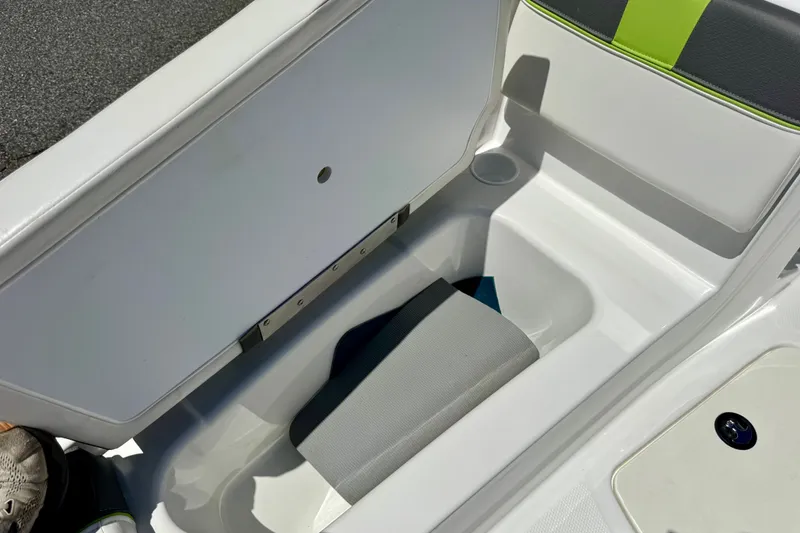 Slide: The Image of 2024 Tahoe T16 boat storage compartment with open lid and cushioned interior. - 66