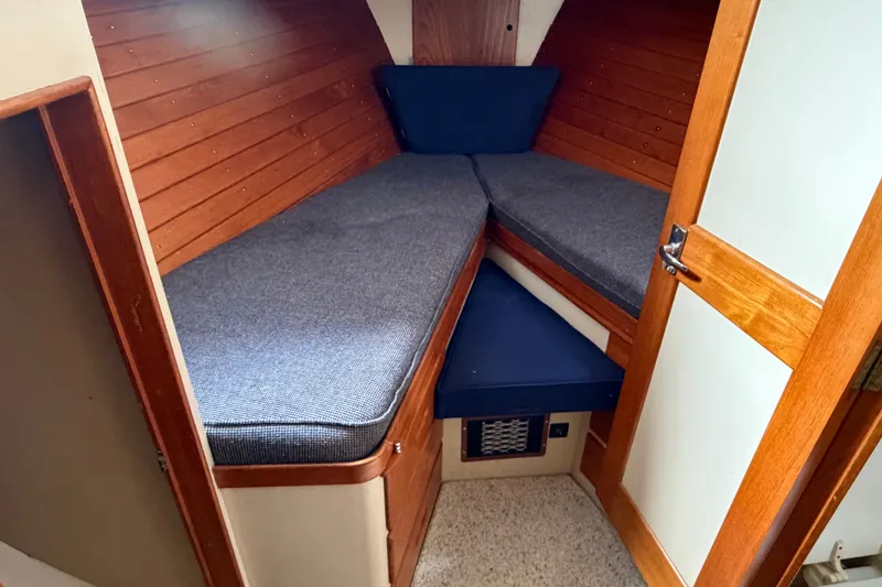 Slide: The Image of Cozy cabin interior of 1969 Grand Banks 42 Classic with wooden paneling and cushioned seating. - 35