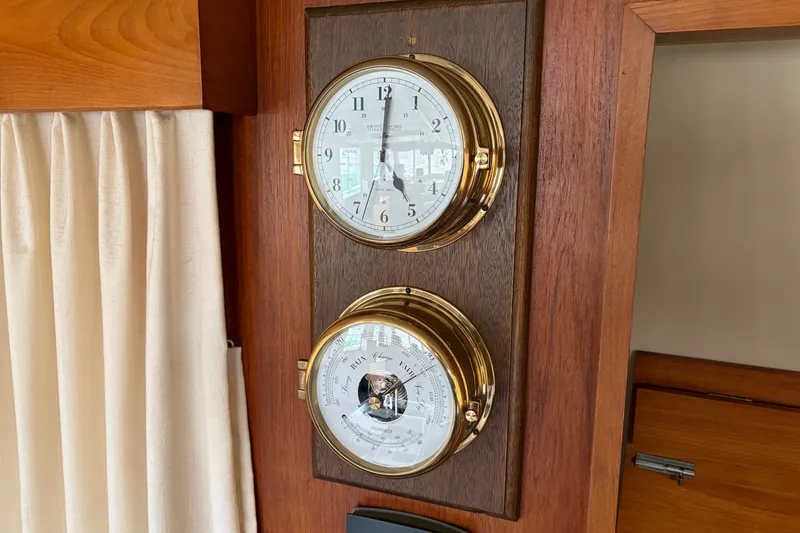 Slide: The Image of Vintage brass clock and barometer on 1969 Grand Banks 42 Classic yacht interior. - 32