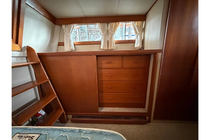 Slide: The Image of Interior of 1969 Grand Banks 42 Classic with wooden cabinetry and ladder. - 45