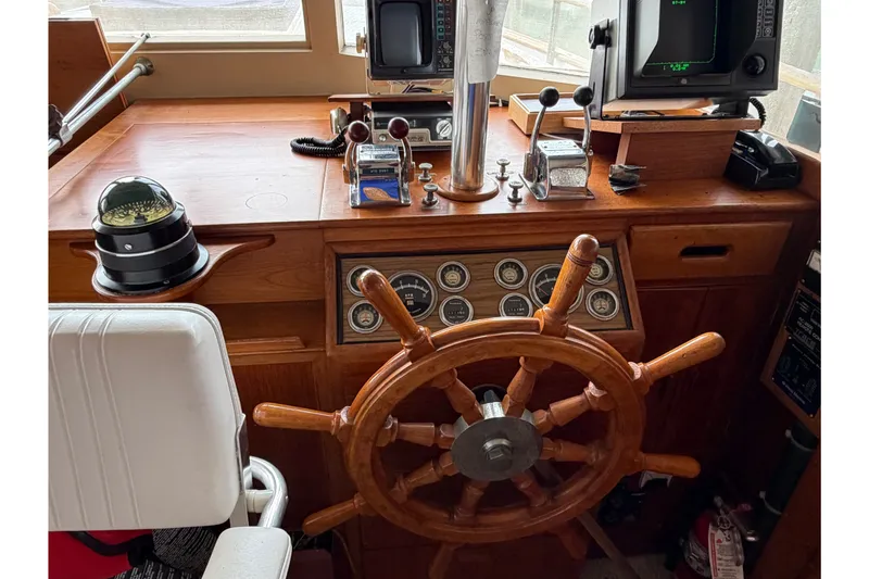 Slide: The Image of Helm of 1969 Grand Banks 42 Classic with wooden wheel and navigation instruments. - 21