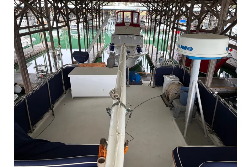 Slide: The Image of 1969 Grand Banks 42 Classic yacht docked in a covered marina. - 16