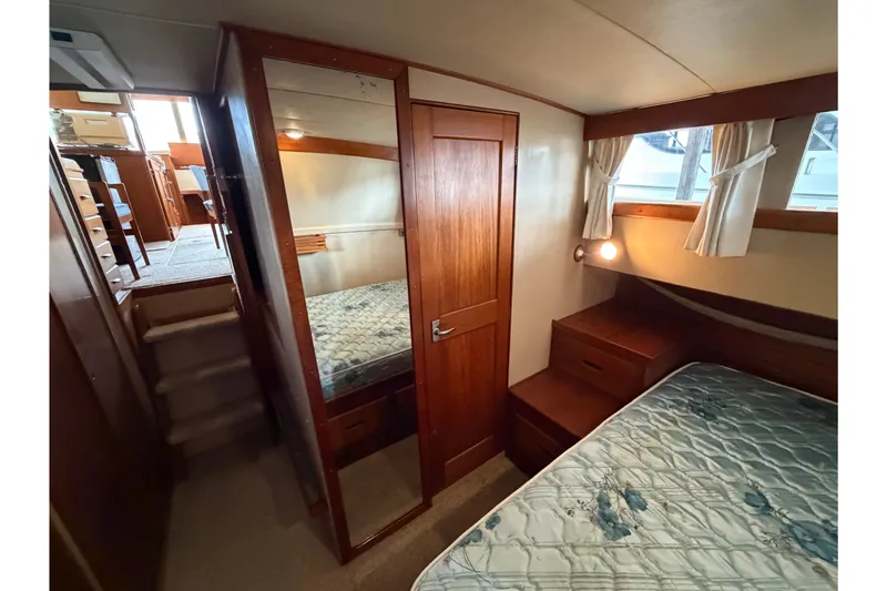 Slide: The Image of Interior of 1969 Grand Banks 42 Classic yacht with wooden cabinetry and cozy sleeping area. - 42