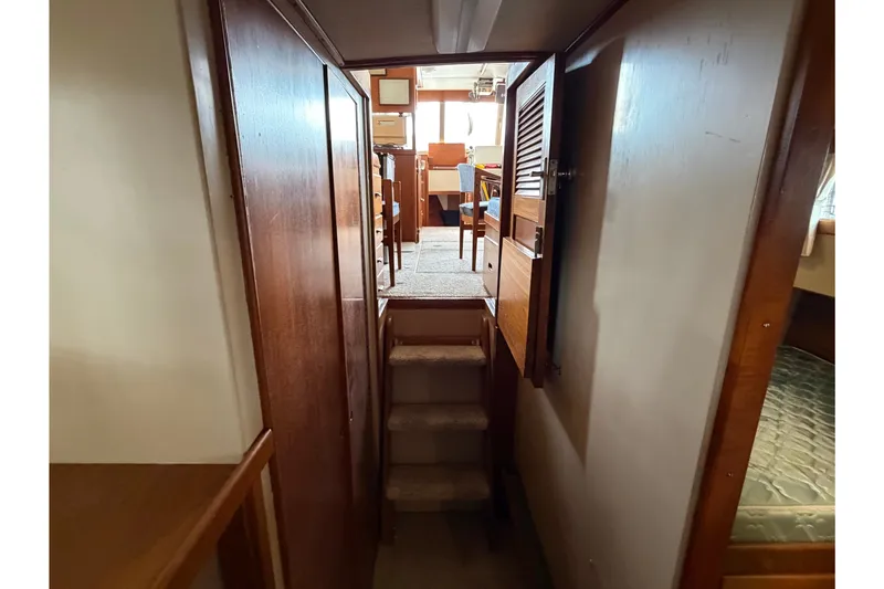 Slide: The Image of Interior view of 1969 Grand Banks 42 Classic yacht with wooden finishes and stairs. - 44