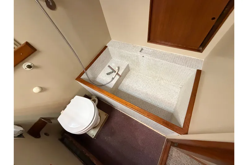 Slide: The Image of Bathroom of 1969 Grand Banks 42 Classic yacht with toilet and tiled shower. - 46