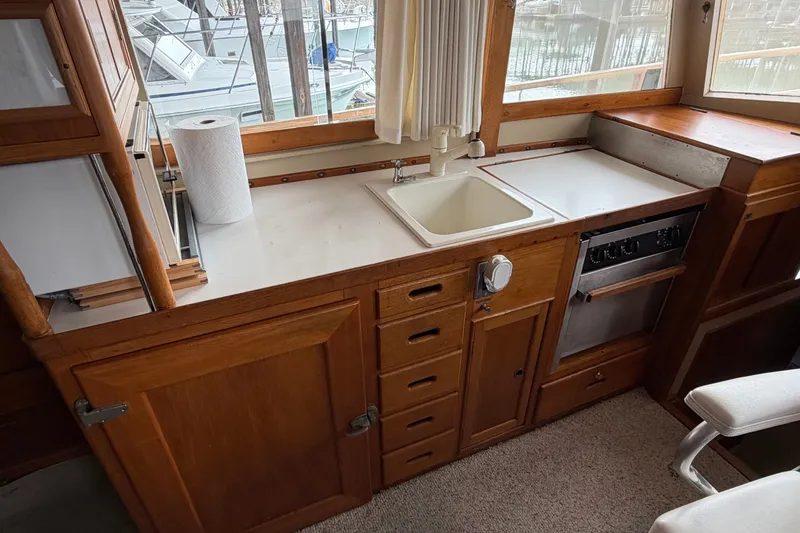 Slide: The Image of Interior of 1969 Grand Banks 42 Classic yacht with wooden cabinetry and compact kitchen. - 34