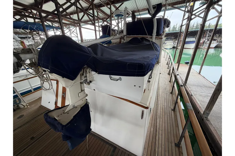Slide: The Image of 1969 Grand Banks 42 Classic yacht docked under a covered marina. - 18