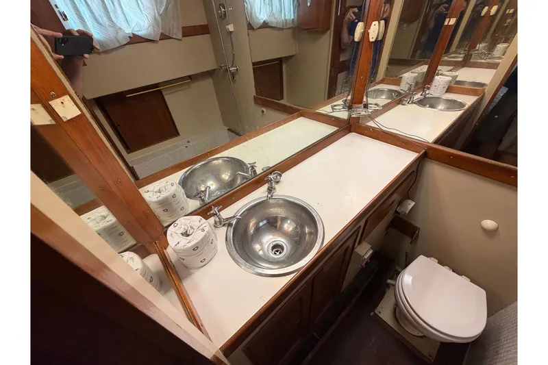 Slide: The Image of Bathroom interior of a 1969 Grand Banks 42 Classic yacht, featuring a sink and toilet. - 48