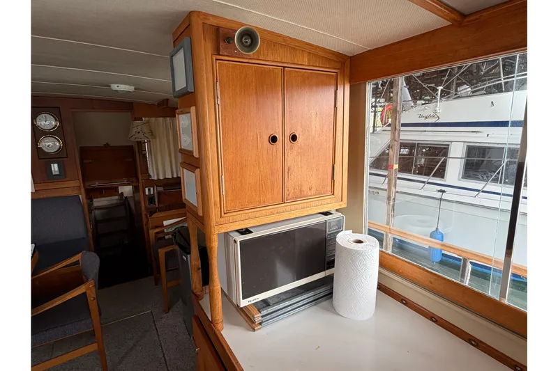 Slide: The Image of Interior of 1969 Grand Banks 42 Classic yacht with wooden cabinetry and microwave. - 40
