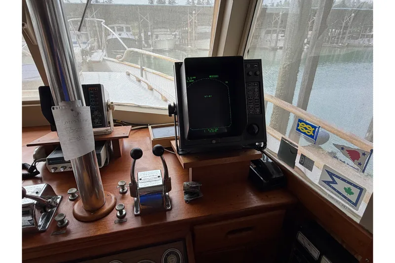 Slide: The Image of Helm of 1969 Grand Banks 42 Classic with navigation equipment and controls. - 22