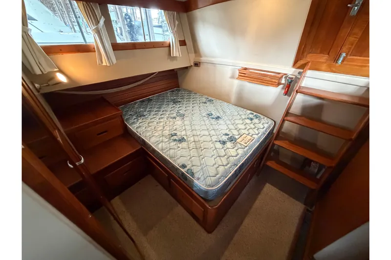 Slide: The Image of Cozy cabin interior of 1969 Grand Banks 42 Classic yacht with bed and wooden furnishings. - 41