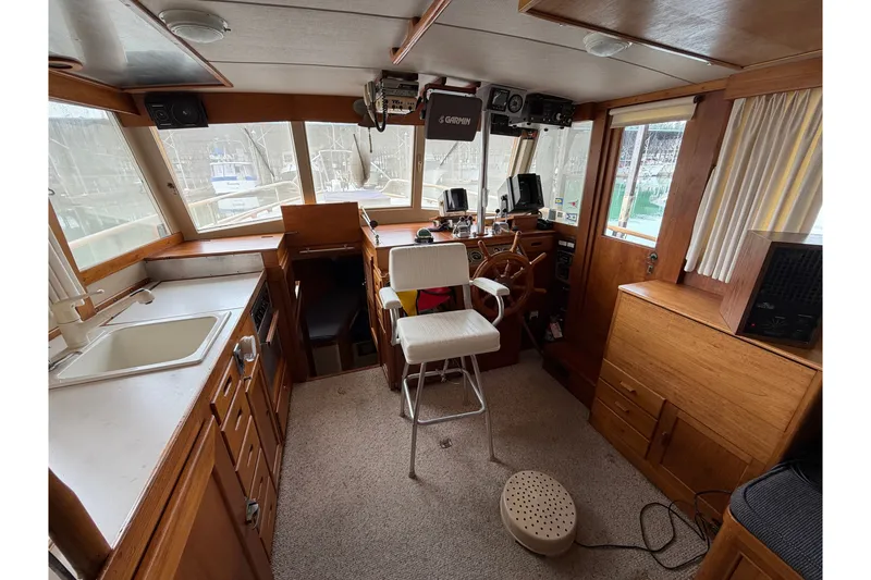 Slide: The Image of Interior of a 1969 Grand Banks 42 Classic boat with wooden cabinetry and helm. - 20
