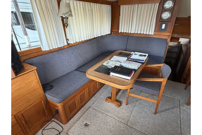 Slide: The Image of Interior of a 1969 Grand Banks 42 Classic yacht with cozy seating and wooden table. - 19